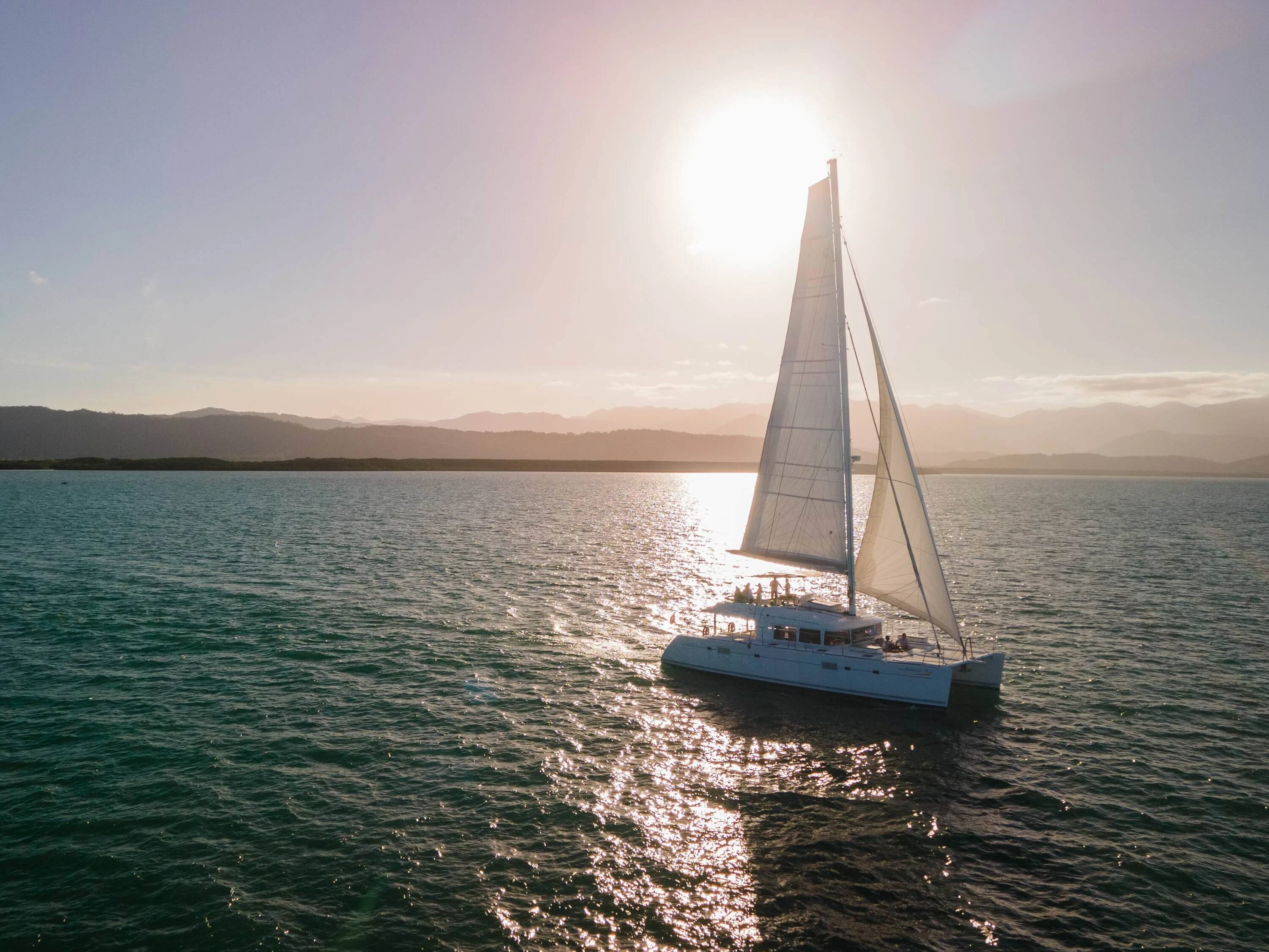 Sailaway cruise sailing out as the sun is setting