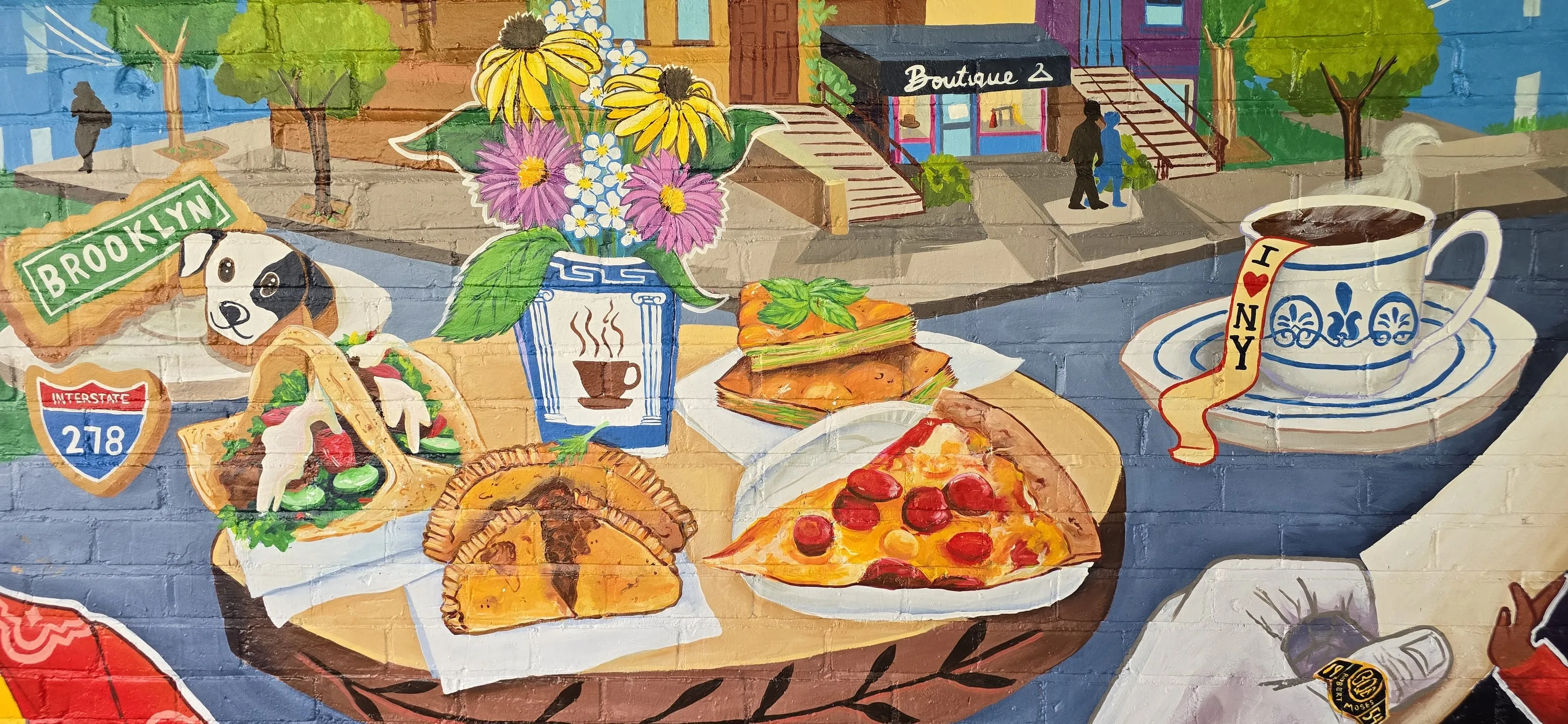 A large, colorful mural of popular NYC foods, like pizza and empanadas.