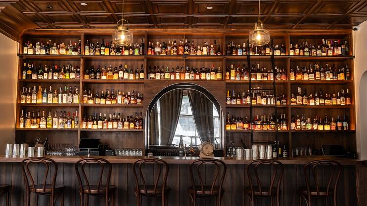 A wooden bar with whiskies