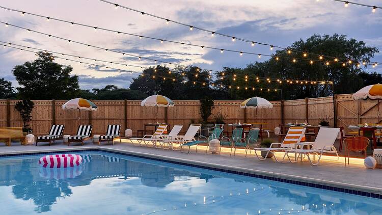 A swimming pool with twinkling lights overhead.