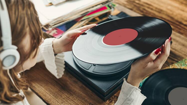 Woman listening to vinyl record