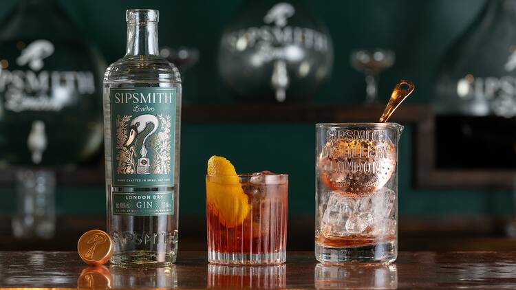 A bottle of Sipsmith’s gin with a cocktail and a mixing glass