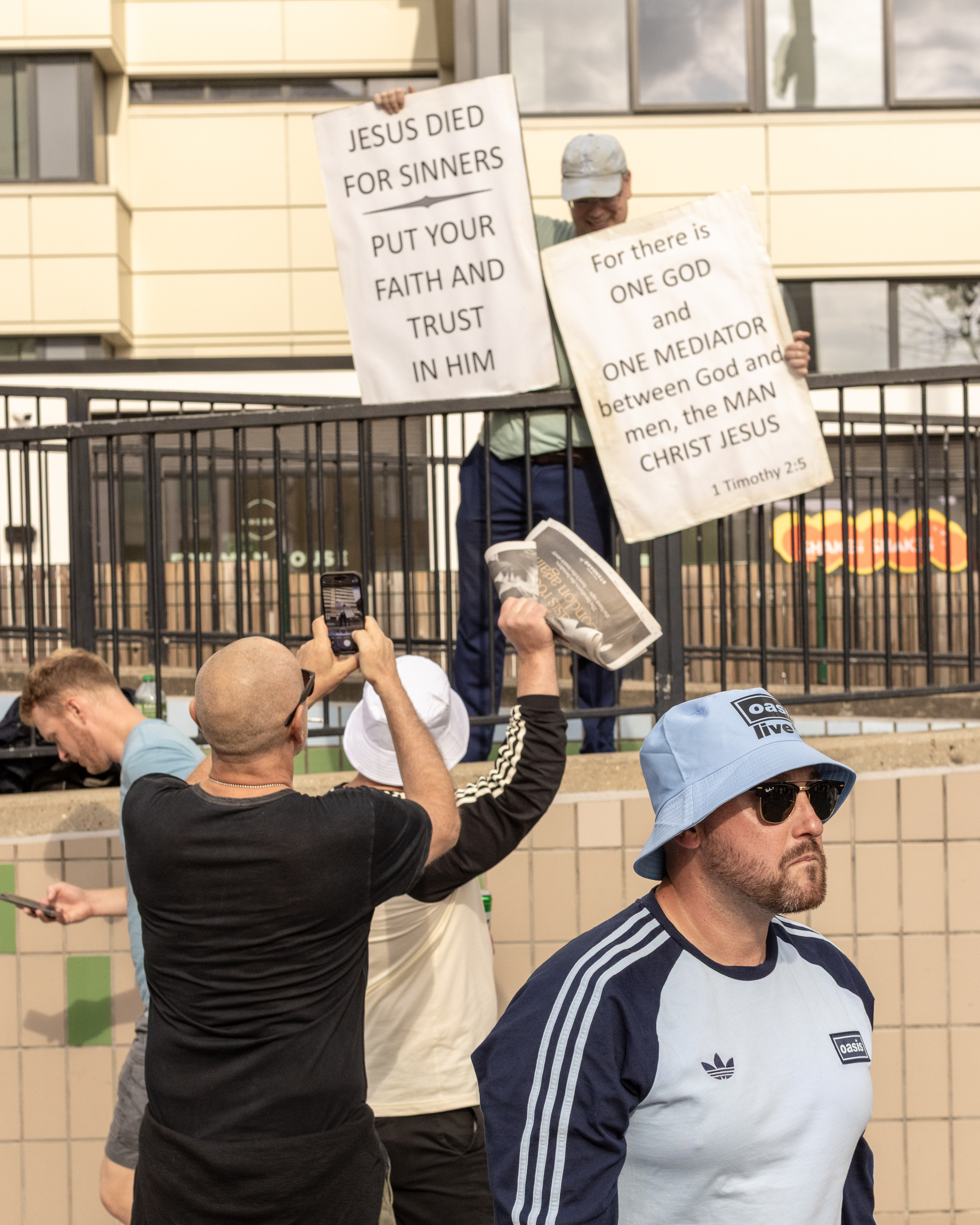 Oasis fans at Wembley Stadium in London for the reunion shows, by Chris Bethell