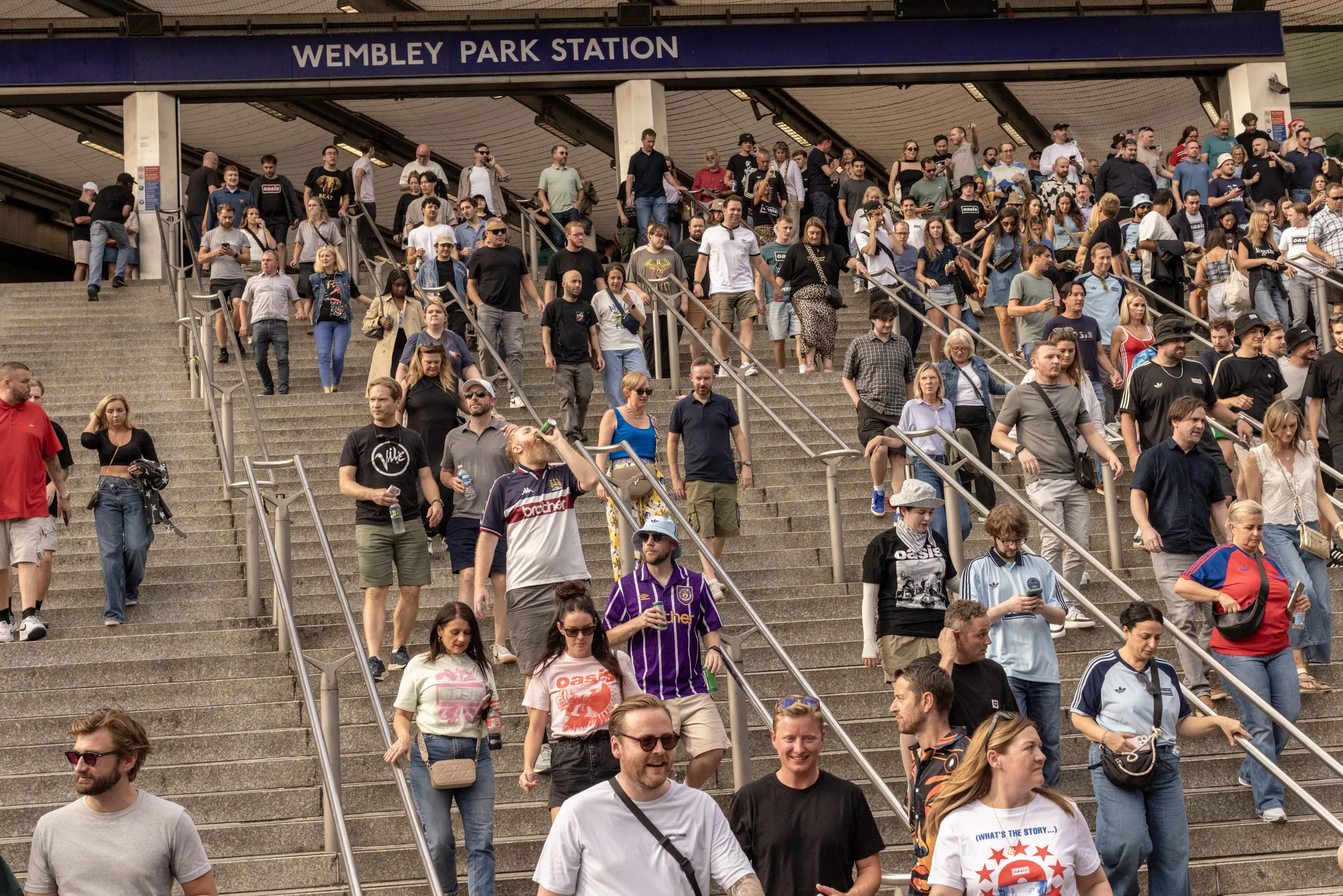 Oasis fans at Wembley Stadium in London for the reunion shows, by Chris Bethell