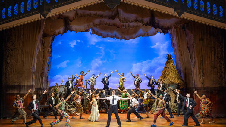 A cast of people dancing and singing on a stage