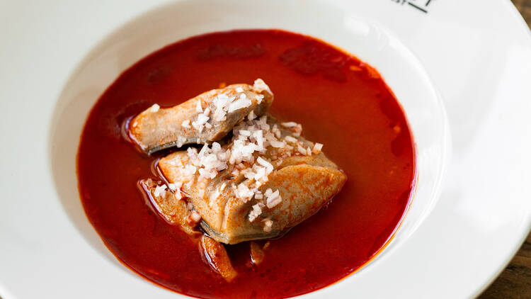 A traditional halászlé (Hungarian fish soup) served in a Time Out Market Budapest bowl, showcasing rich paprika broth and tender fillets.