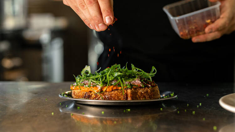  A signature dish from Casa Christa — toasted bread topped with fresh herbs, seasonal ingredients, and a modern countryside twist.