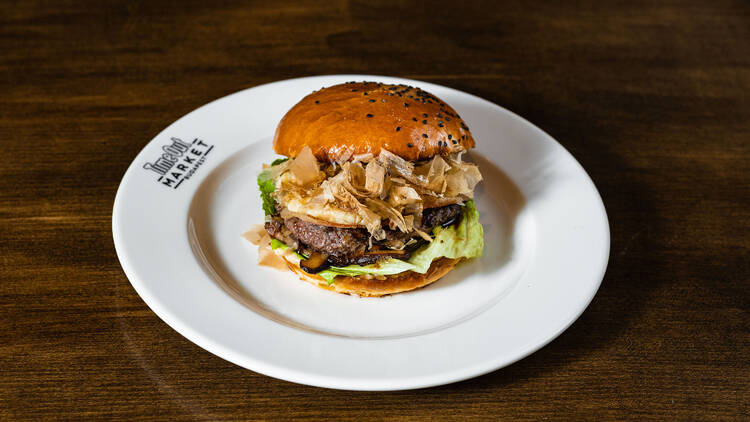 Tuning Burger’s gourmet-style creation served in a soft bun, topped with lettuce, house-made sauce, and umami-rich layers like mushrooms and bonito flakes.