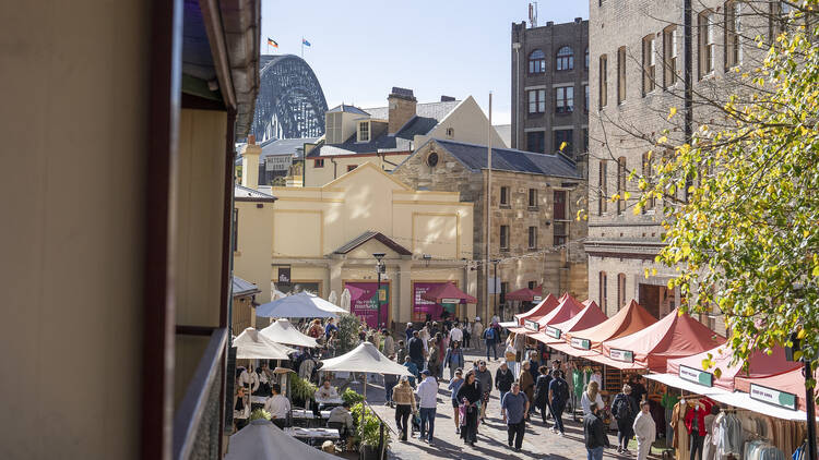 A laneway in The Rocks with market stalls and bridge views