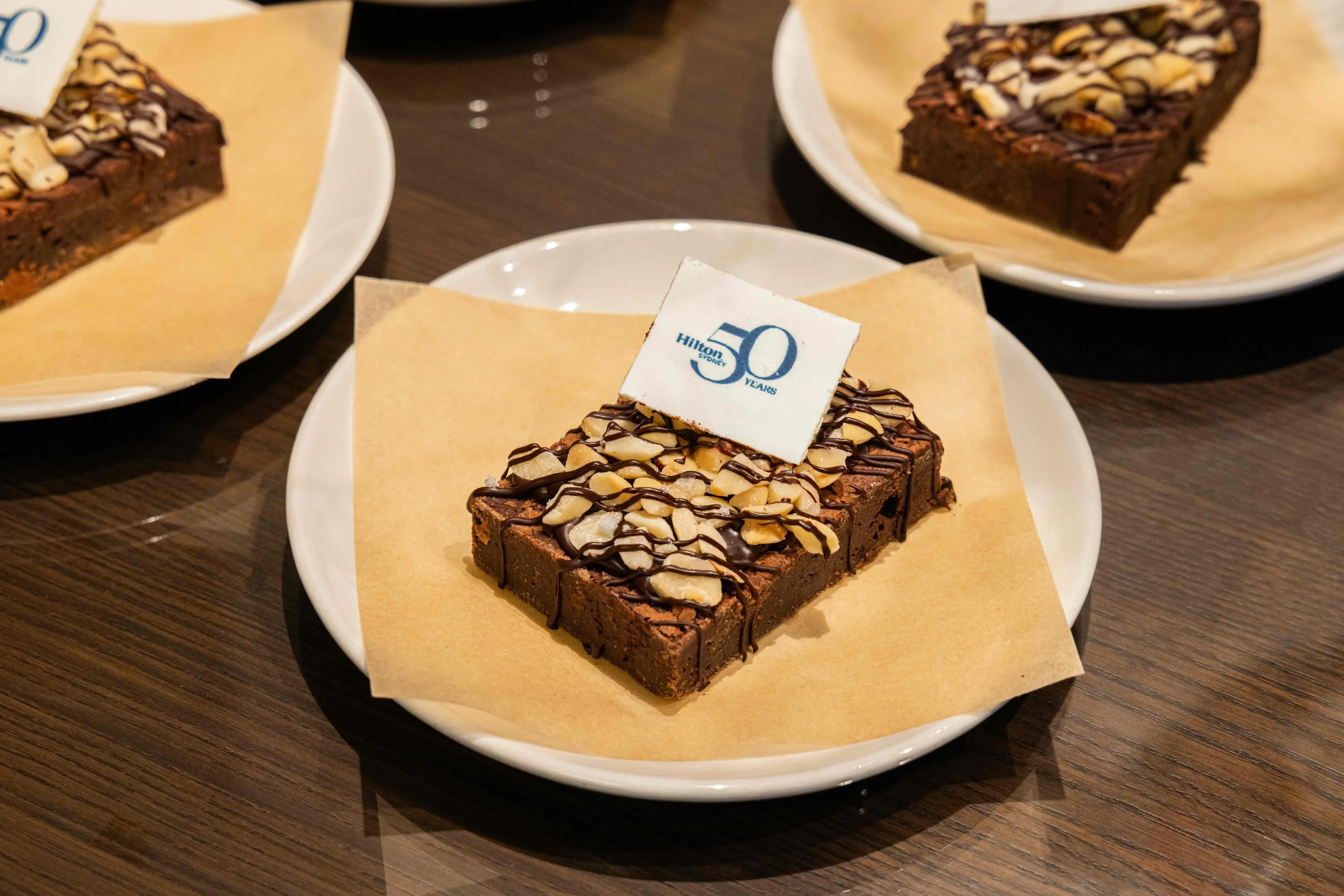 Brownie with macadamias on plate