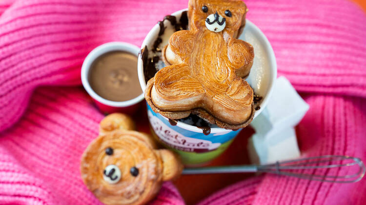 A teddy bear pastry on top of a hot chocolate.