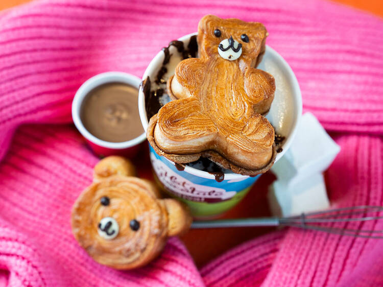 A teddy bear pastry on top of a hot chocolate.