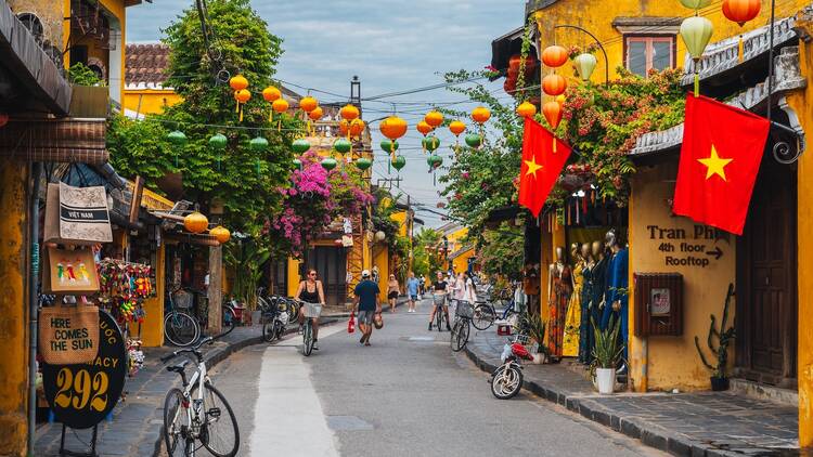 Streets with traditional ancient yellow houses in the old town in Hoi An city in Vietnam at day. Hoi An, Vietnam - September 12, 2024
