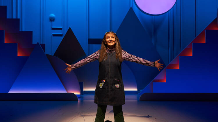 Marina Prior on stage with her arms outstretched in 'Kimberly Akimbo'.