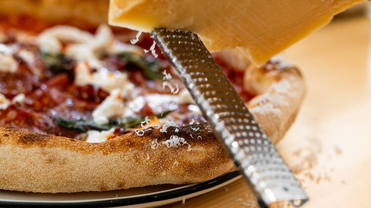 The Anyukám Mondta pizza – light and airy dough with a crisp edge, topped with freshly grated Parmesan melting into the silky tomato sauce.