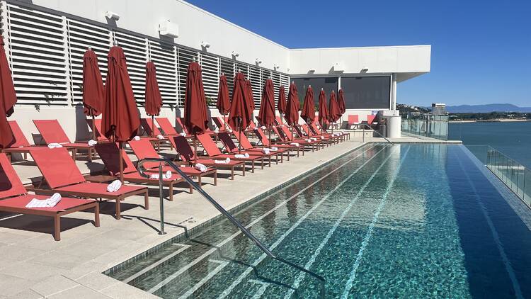 Infinity pool with orange lounges