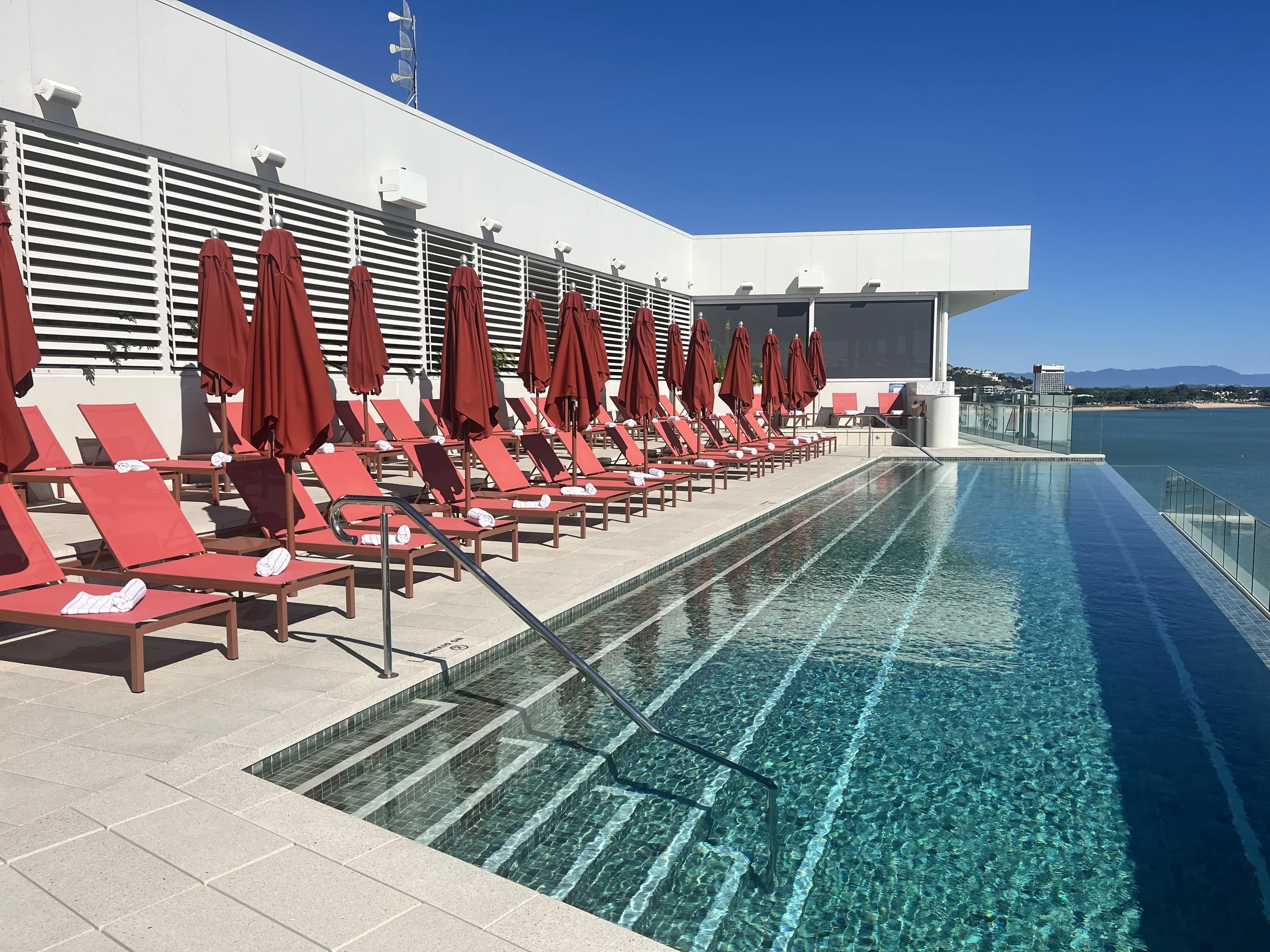 Infinity pool with orange lounges