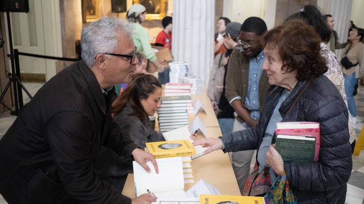 An author signs a book for a fan.