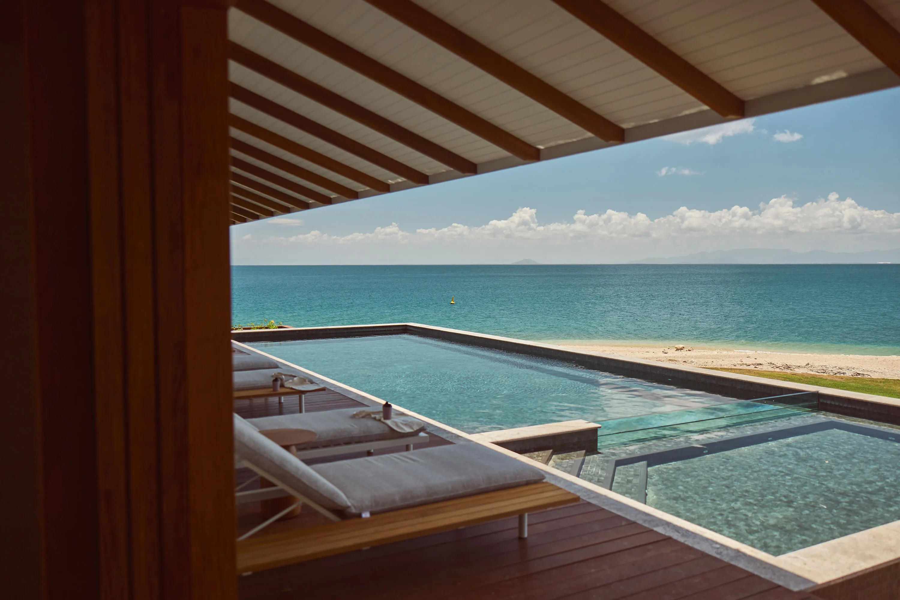 Day beds overlooking pool and ocean