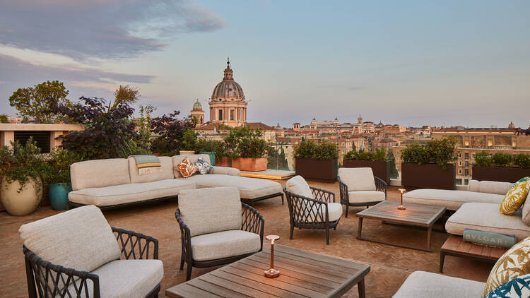 Outdoor terrace at Bulgari Roma, with views of Rome in the background