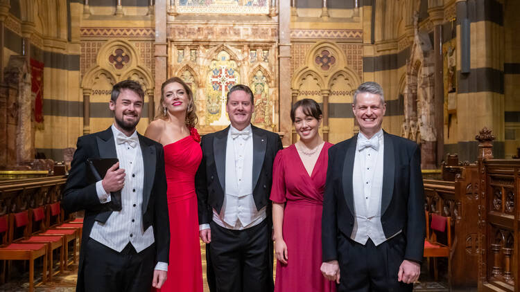 Five musicians standing in St Paul's Cathedral.
