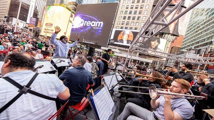 An ensemble of jazz musicians playing with trumpets and flutes