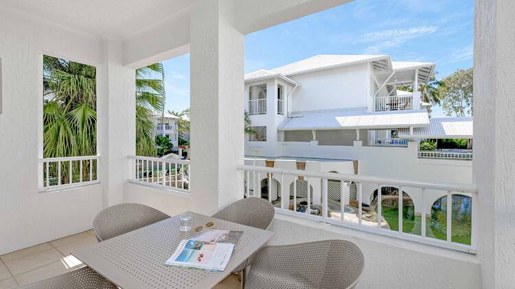 A balcony of a hotel room with a view of a blue sky. 