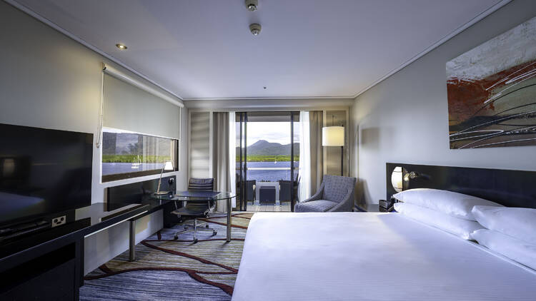 A hotel room with a view out to the ocean. 