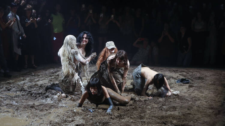 Models wrestling in mud at the Elena Velez fashion show