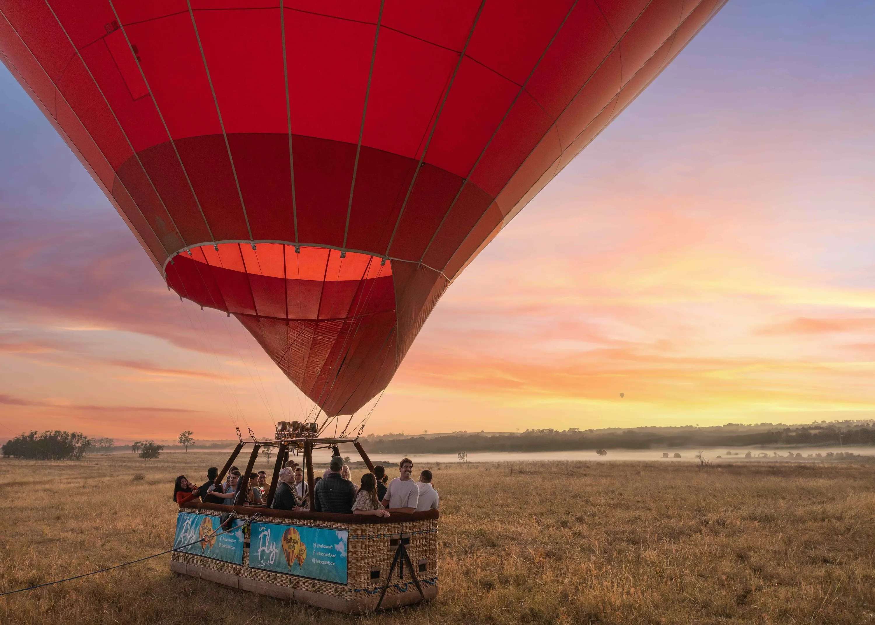 Hot air balloon on ground at sunrise