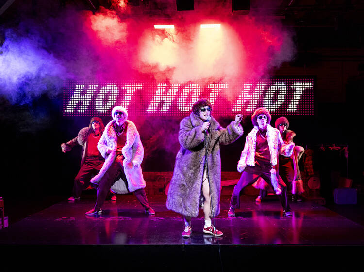 Members of Pony Cam on stage in 'The Orchard' against a backdrop that says Hot Hot Hot.