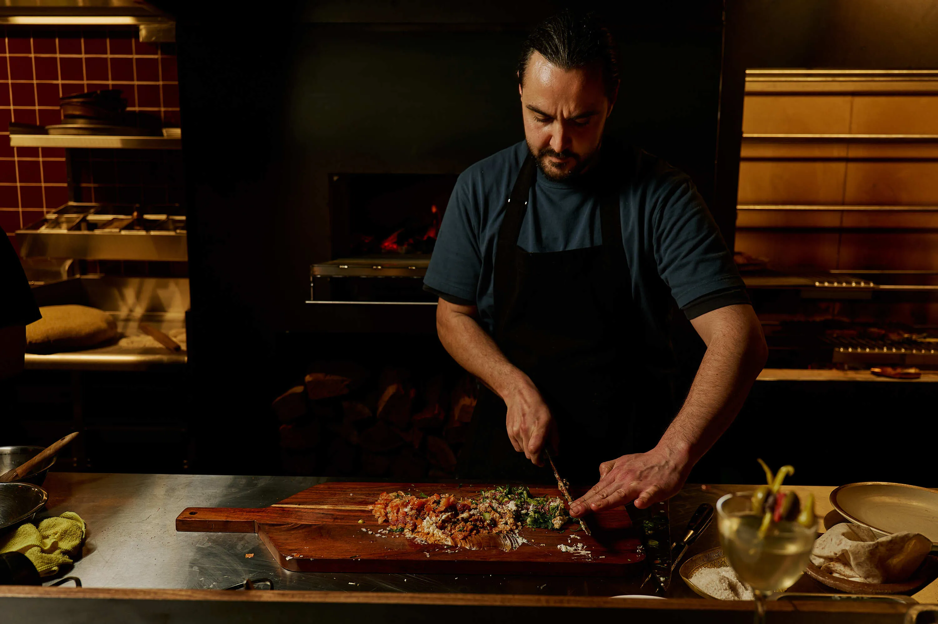 Chef Tom Sarafian preparing food in Zareh's kitchen.