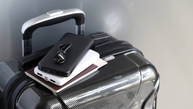 Power bank and passport on luggage for travel of holiday 1753674049
