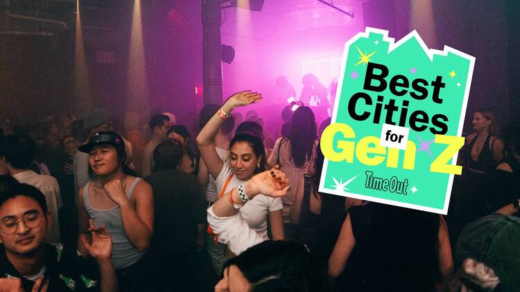 A group of young people dance at a club.