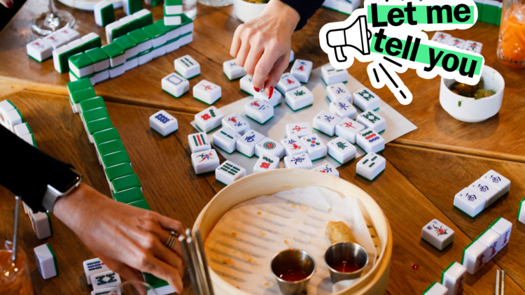 A table of mahjong tiles and steamer baskets