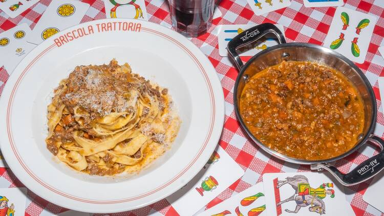 A dish of Tagliatelle Al Ragu sitting on a bed of cards