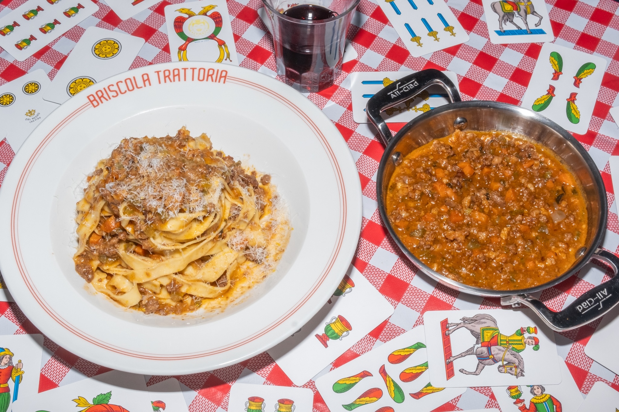 A dish of Tagliatelle Al Ragu sitting on a bed of cards