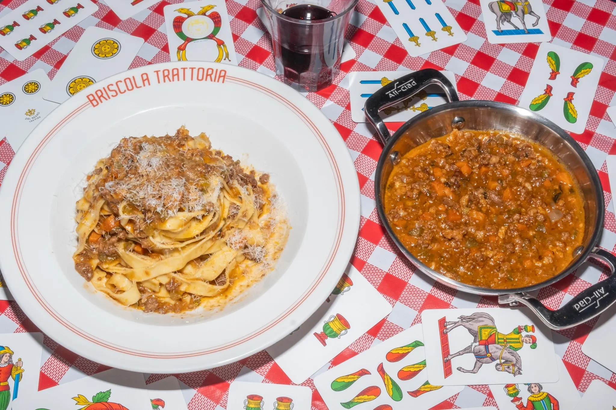 A dish of Tagliatelle Al Ragu sitting on a bed of cards