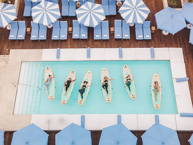 I tried stand-up paddleboard yoga for the first time—on a hotel rooftop I tried stand-up paddleboard yoga for the first time—on a hotel rooftop