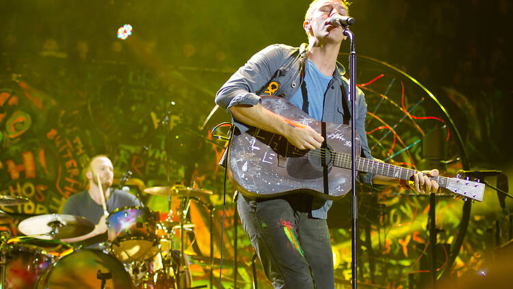 Coldplay's Chris Martin playing 