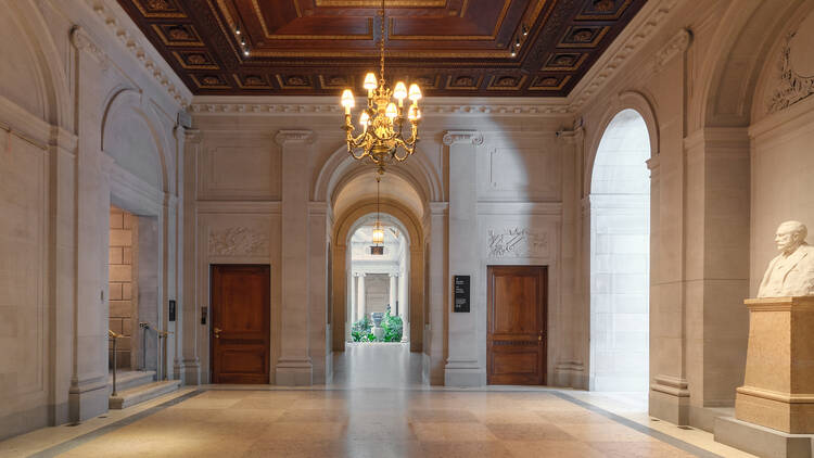 A formal entryway with a chandelier.