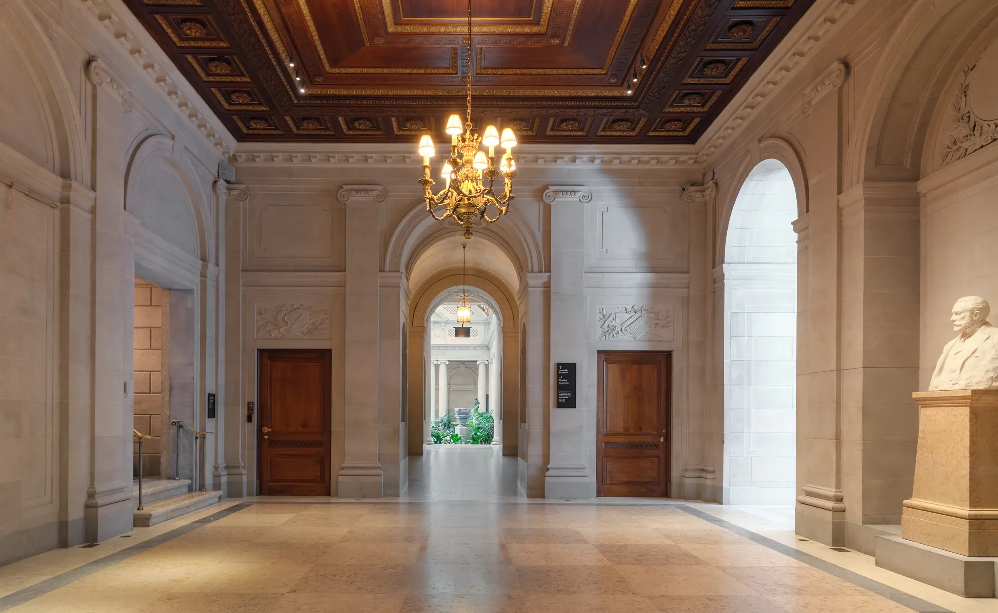 A formal entryway with a chandelier.