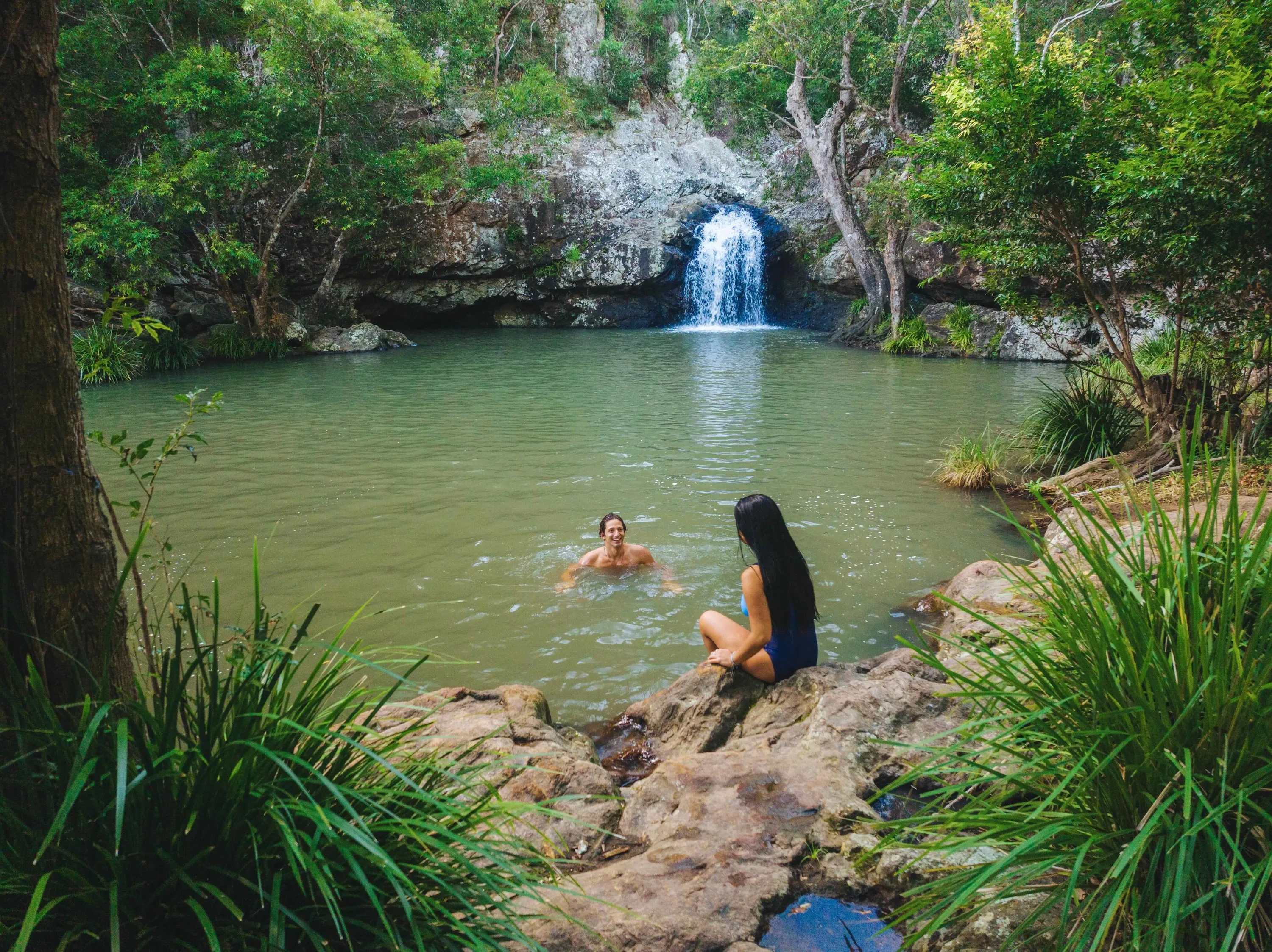 Couple having a swim in the rock pool at Kondalilla Falls