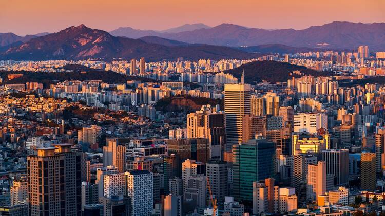Gold sunset of Seoul cityscapes with high rise office buildings and skyscrapers in Seoul city, Republic of Korea in winter blue sky and cloud