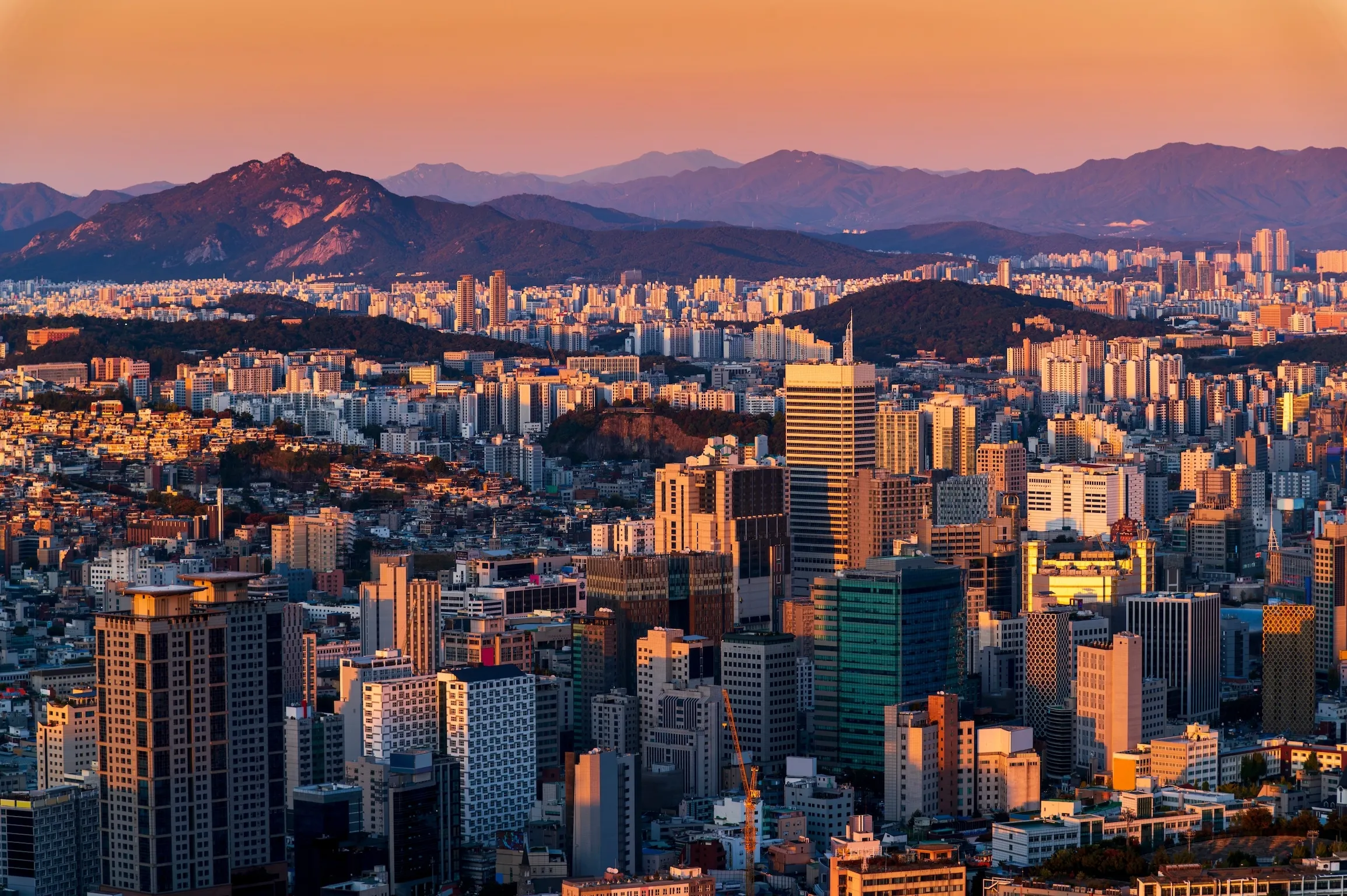 Gold sunset of Seoul cityscapes with high rise office buildings and skyscrapers in Seoul city, Republic of Korea in winter blue sky and cloud