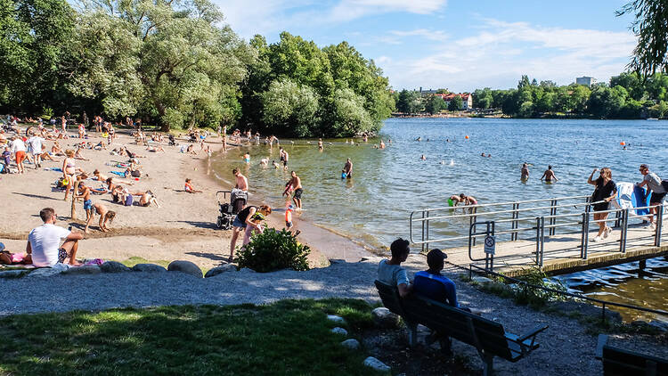 People hanging out by a lake in Stockholm, Sweden