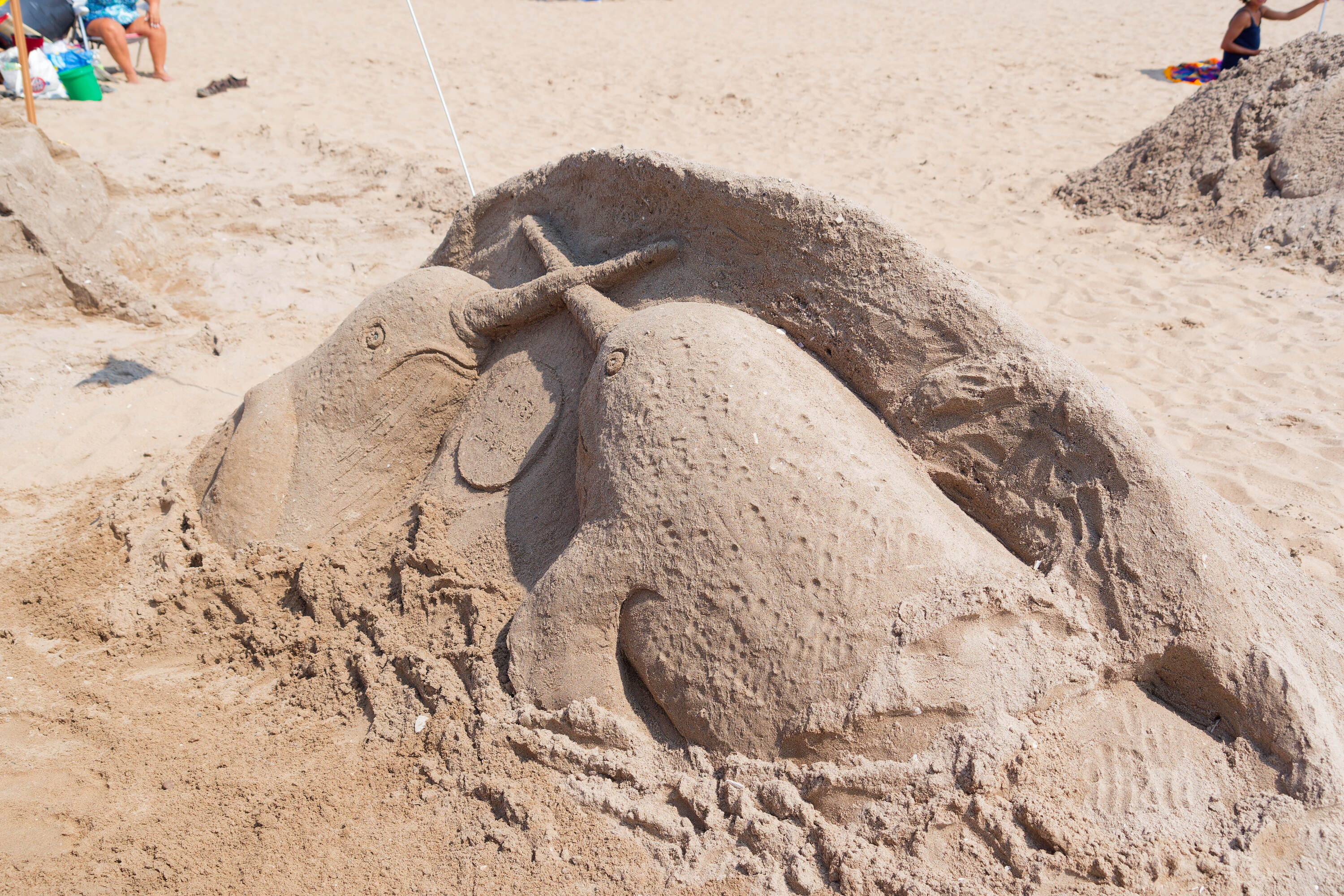 A sand sculpture of two narwhals.