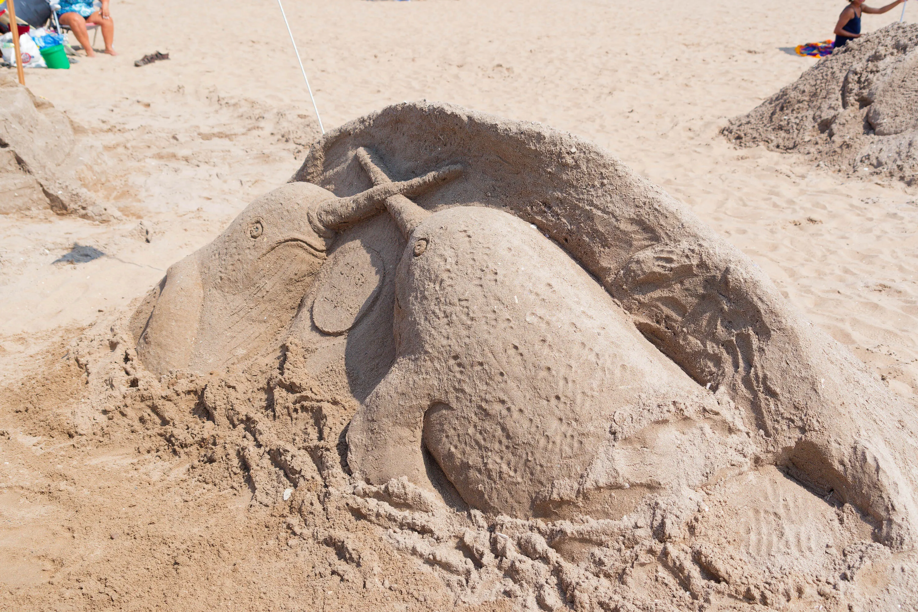 A sand sculpture of two narwhals.