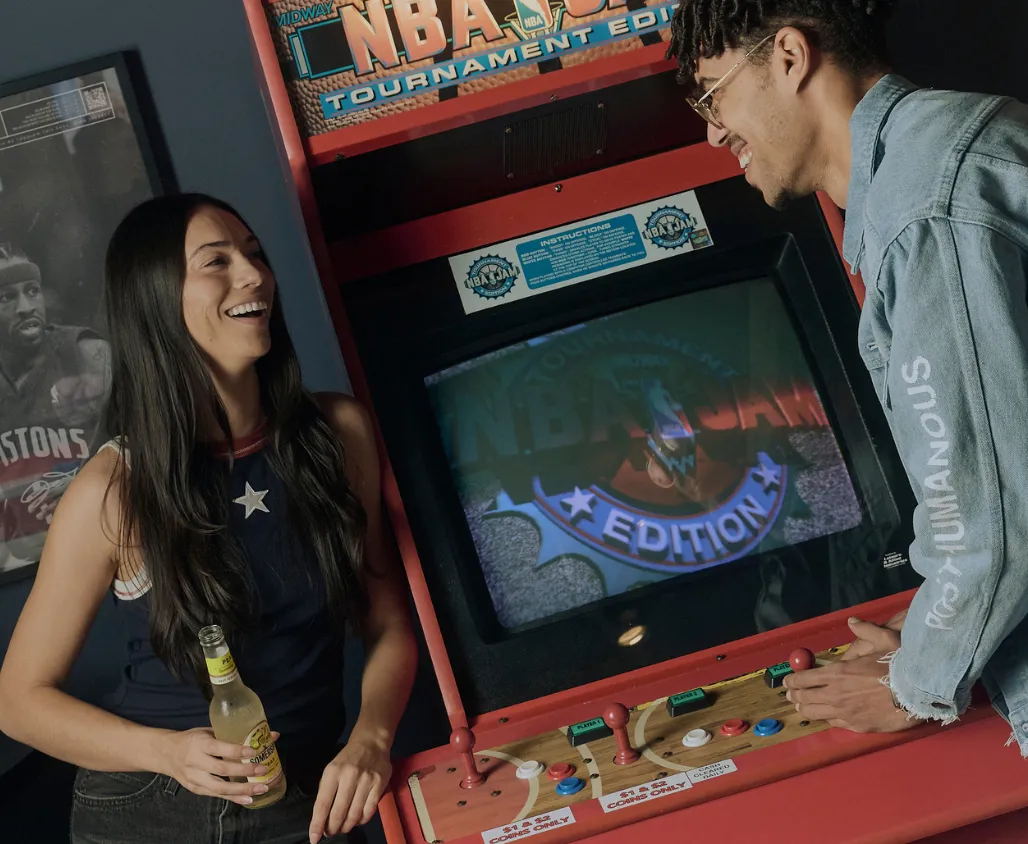 Pair of pub patrons enjoying an arcade game.