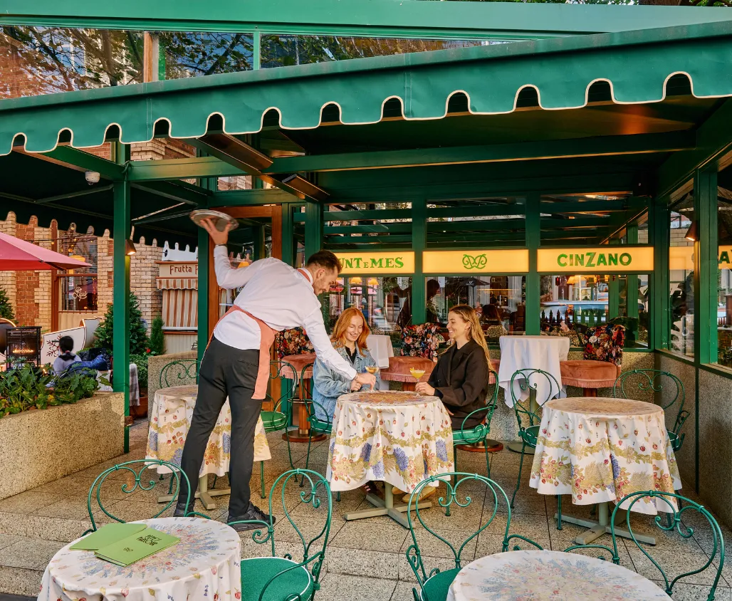 Waiter serving a pair of women at Pepe's Parlour.